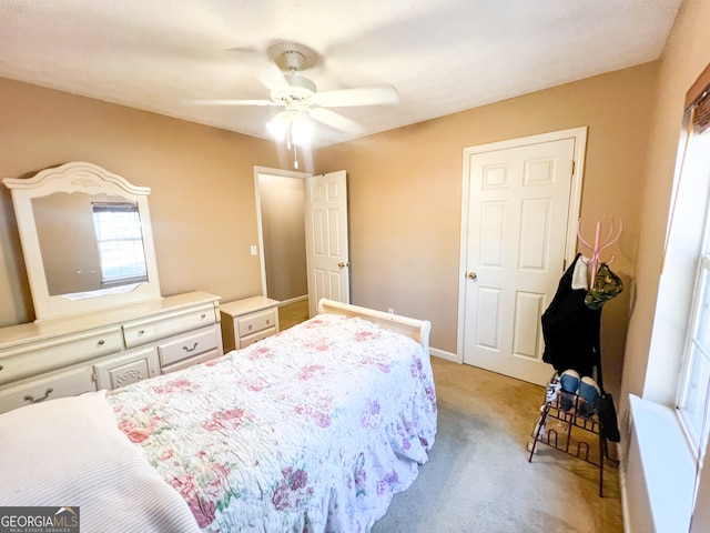 bedroom featuring light colored carpet and ceiling fan