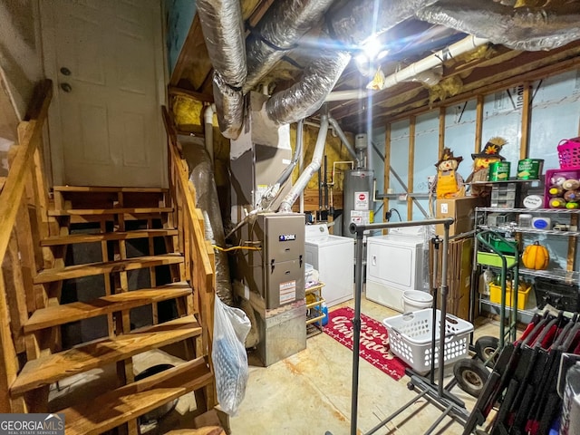 basement with water heater and washing machine and clothes dryer