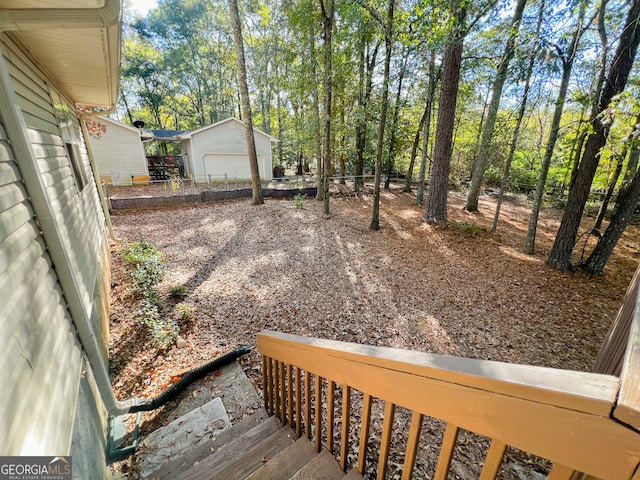 view of yard with a garage and an outdoor structure