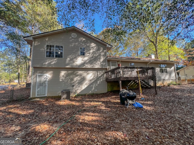 rear view of house with a deck and central AC unit