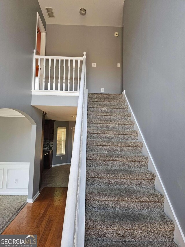 staircase with hardwood / wood-style floors