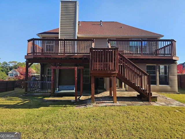 rear view of house featuring a lawn, a patio area, and a wooden deck