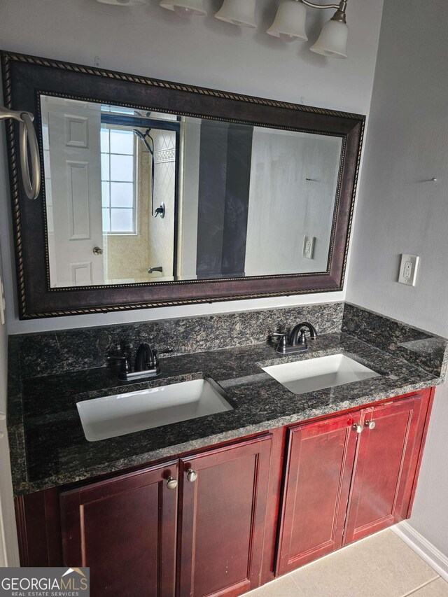 bathroom featuring tile patterned flooring, vanity, and walk in shower