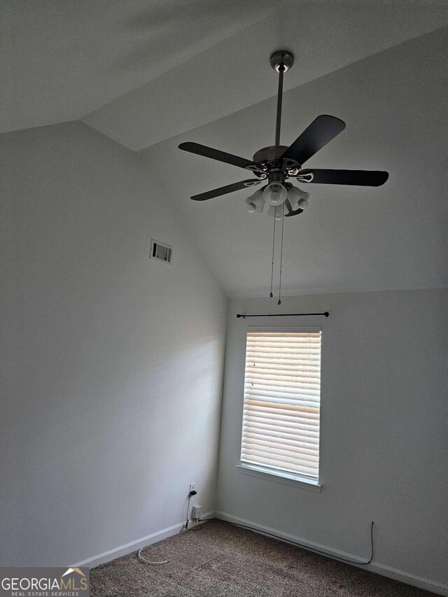 carpeted empty room with ceiling fan and lofted ceiling