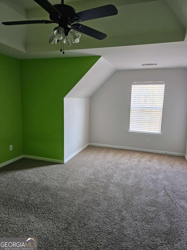 bonus room featuring carpet flooring, vaulted ceiling, and ceiling fan