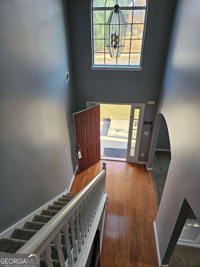 foyer entrance featuring hardwood / wood-style floors and an inviting chandelier