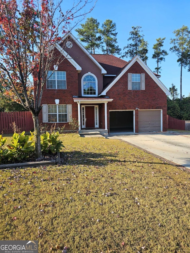 front facade featuring a front yard and a garage