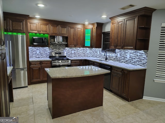 kitchen featuring sink, stainless steel appliances, backsplash, extractor fan, and a kitchen island