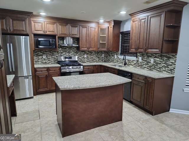 kitchen featuring backsplash, dark brown cabinetry, stainless steel appliances, and ventilation hood