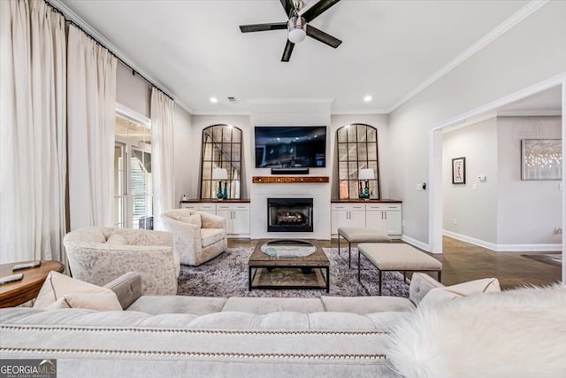 living room with wood-type flooring, ceiling fan, and crown molding