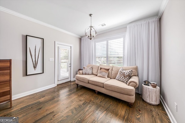 living room featuring dark wood-type flooring, a chandelier, and crown molding