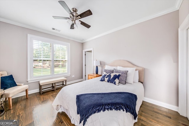 bedroom with dark wood-type flooring, ceiling fan, and ornamental molding