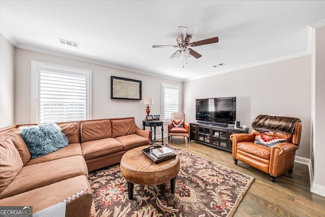 living room featuring ornamental molding, a wealth of natural light, hardwood / wood-style flooring, and ceiling fan