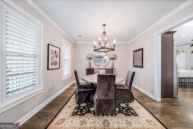 dining area featuring ornamental molding, dark hardwood / wood-style flooring, and a notable chandelier