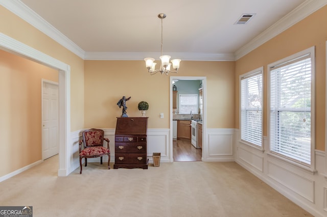 sitting room with light colored carpet, an inviting chandelier, and crown molding