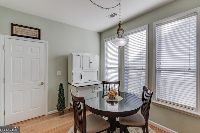 dining space with light hardwood / wood-style flooring