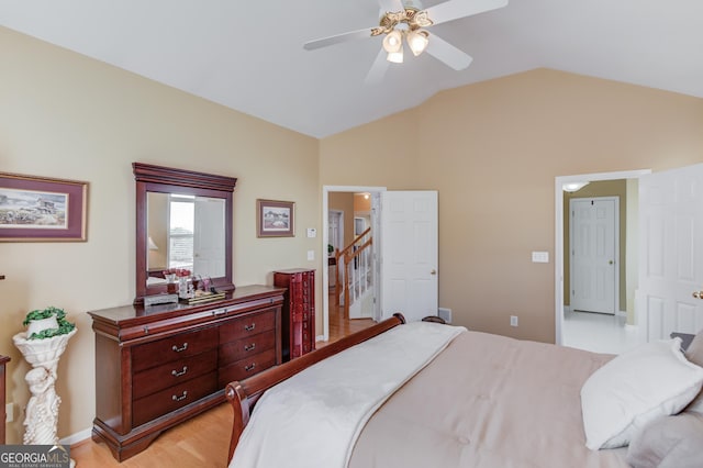 bedroom with ceiling fan, light hardwood / wood-style floors, and lofted ceiling