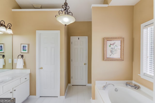 bathroom with tile patterned flooring, vanity, and a tub