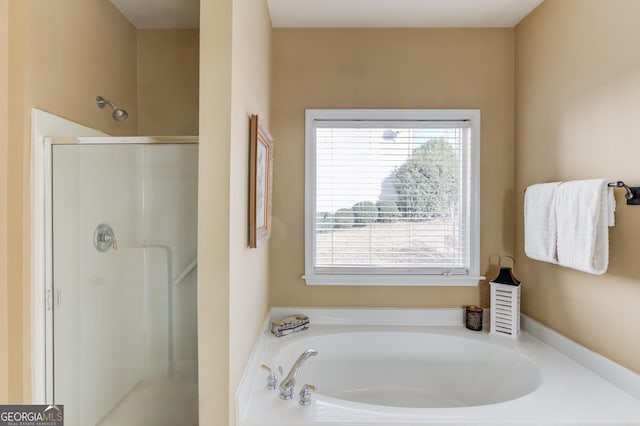 bathroom featuring separate shower and tub