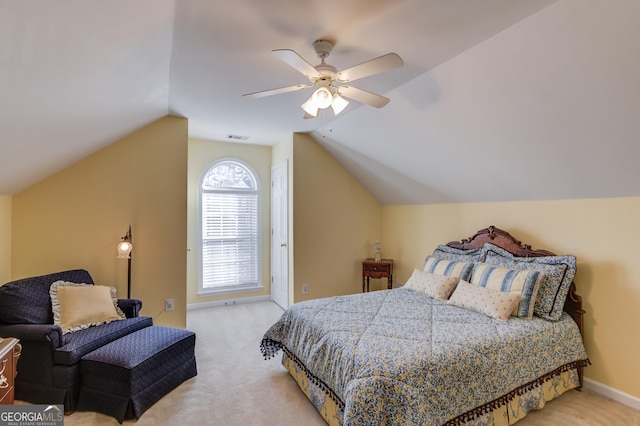 bedroom featuring light carpet, ceiling fan, and vaulted ceiling