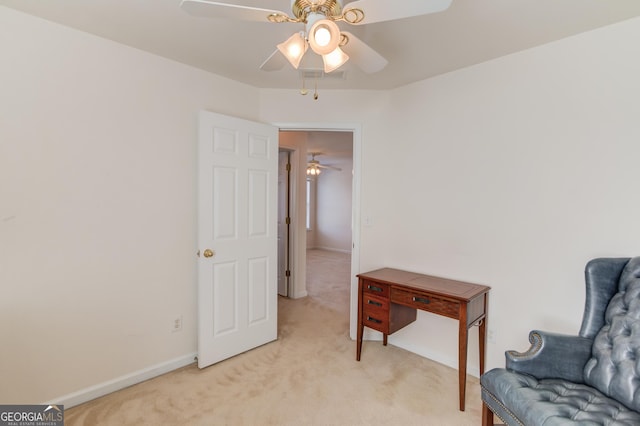 living area with light carpet and ceiling fan