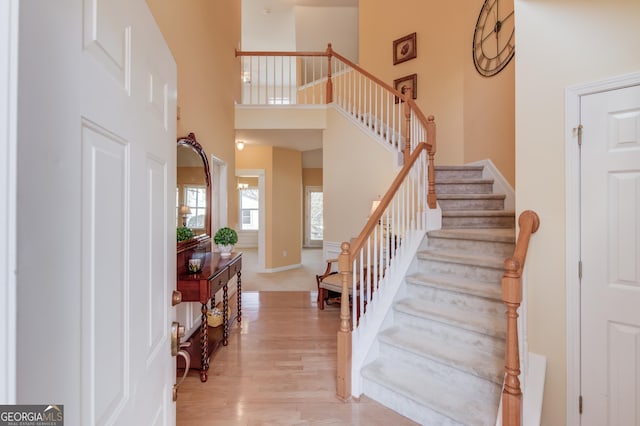 entryway featuring light hardwood / wood-style floors and a high ceiling