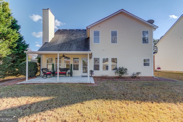 back of house with a patio area, ceiling fan, and a yard