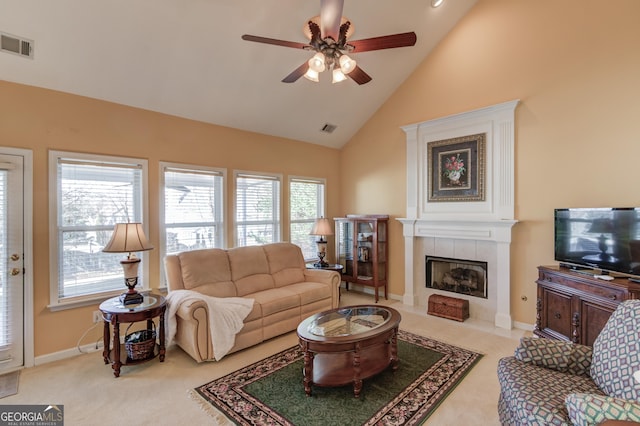 carpeted living room featuring ceiling fan, a fireplace, and high vaulted ceiling