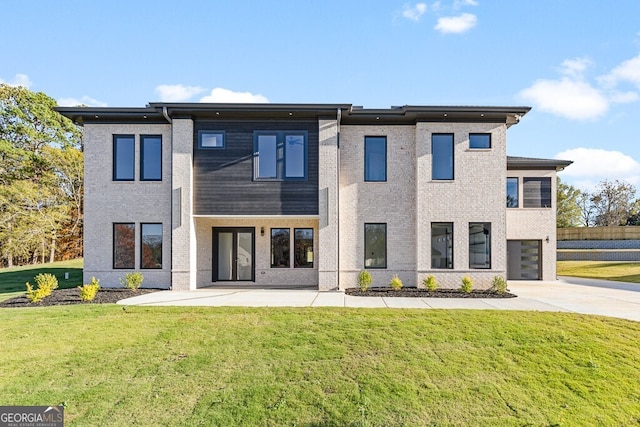 rear view of property featuring a lawn and a patio area