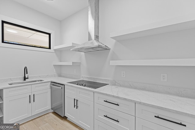 kitchen with black electric stovetop, wall chimney exhaust hood, stainless steel dishwasher, and white cabinets