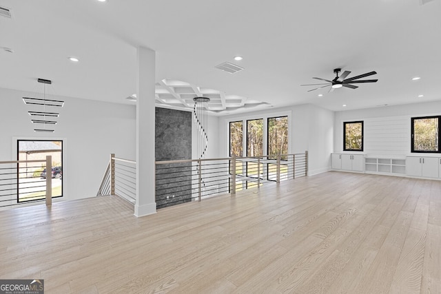 unfurnished living room with plenty of natural light, ceiling fan, and light hardwood / wood-style flooring