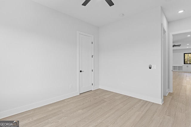 spare room with ceiling fan and light hardwood / wood-style flooring