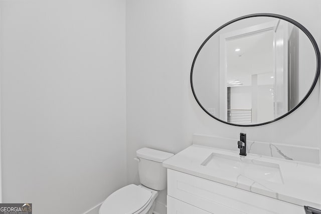 bathroom featuring vanity and toilet