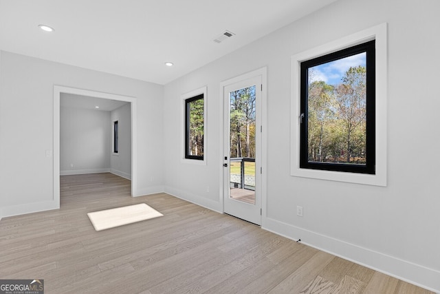 spare room with light hardwood / wood-style floors