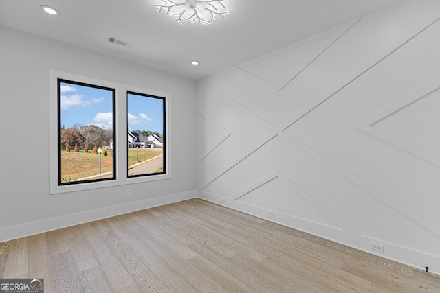 spare room with light wood-type flooring