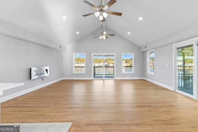 unfurnished living room with light wood-style floors, baseboards, high vaulted ceiling, and recessed lighting