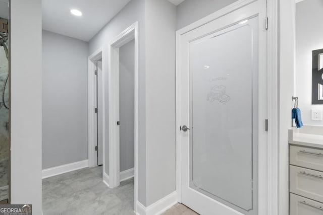 bathroom featuring recessed lighting, baseboards, a shower, and vanity