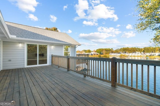 wooden terrace featuring a water view