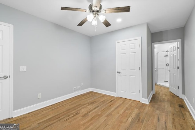 unfurnished bedroom with light wood finished floors, ceiling fan, and baseboards