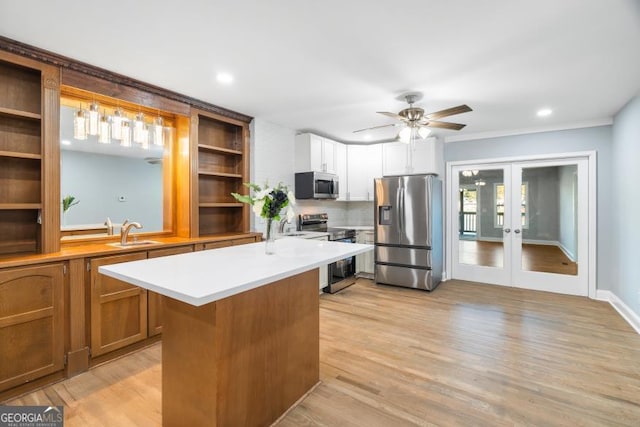 kitchen with stainless steel appliances, light wood-style floors, light countertops, french doors, and open shelves