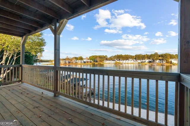 wooden deck featuring a water view