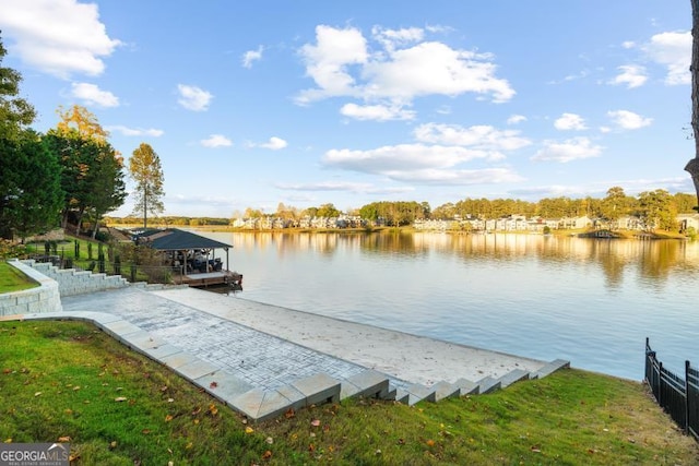 dock area featuring a water view and fence