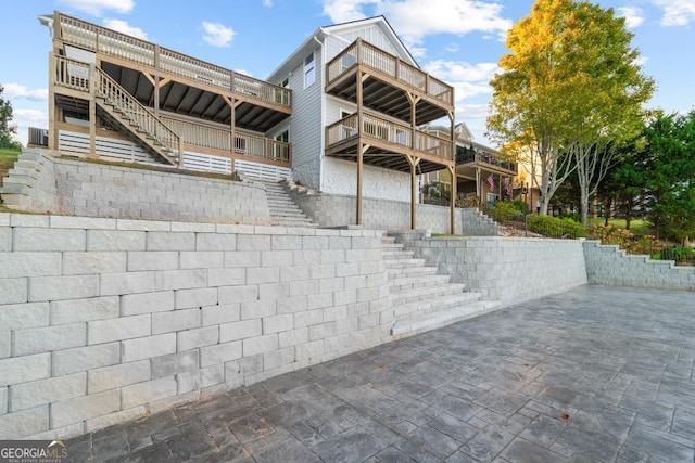 rear view of property featuring stairway