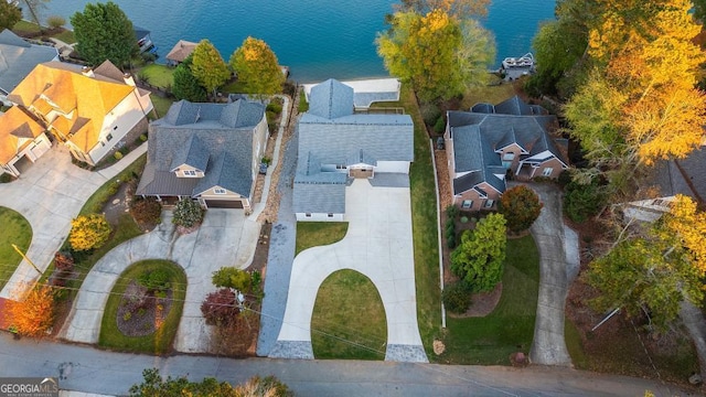 birds eye view of property featuring a water view and a residential view