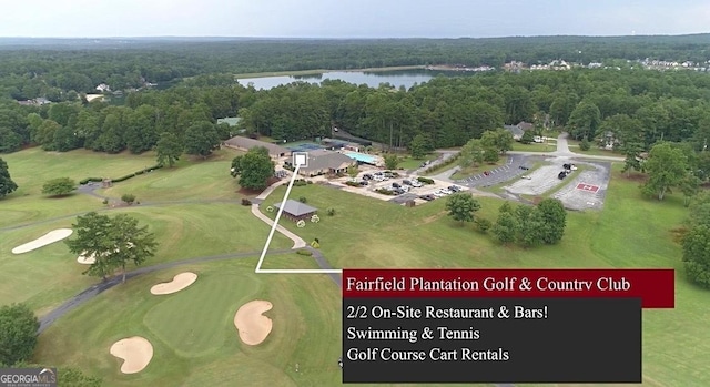 bird's eye view featuring golf course view, a water view, and a wooded view