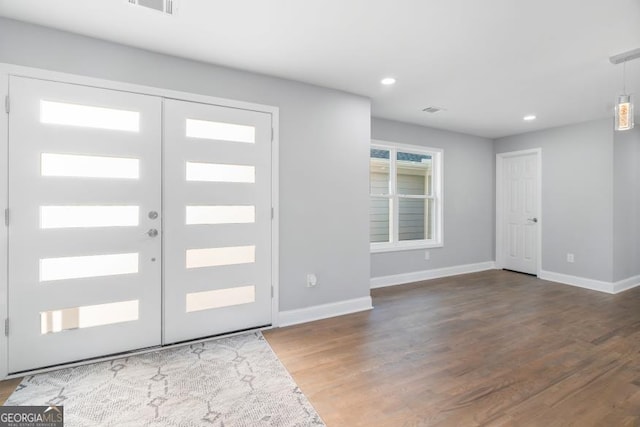 entrance foyer with recessed lighting, french doors, baseboards, and wood finished floors