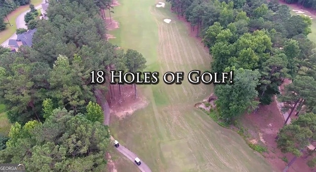 birds eye view of property featuring a forest view