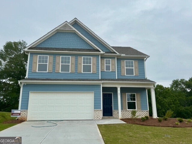 89 Hampton Ridge Way, Jefferson, GA 30549 - craftsman house with an attached garage, a porch, a front yard, driveway, and roof with shingles