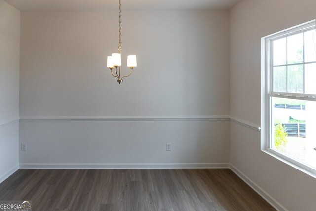 89 Hampton Ridge Way, Jefferson, GA 30549 - empty room featuring a chandelier, dark wood-style floors, healthy amount of natural light, and baseboards