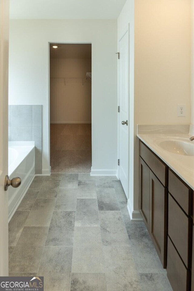 89 Hampton Ridge Way, Jefferson, GA 30549 - bathroom with a bath, a spacious closet, and vanity